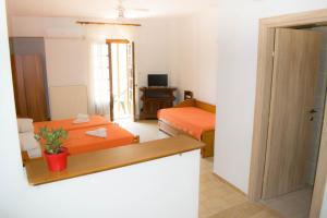 a room with a bedroom with a bed and a desk at Eleni's House Skiathos in Skiathos