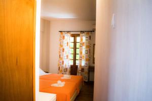 a small room with two beds and a window at Eleni's House Skiathos in Skiathos