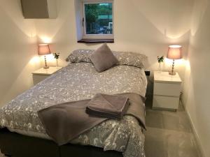a bedroom with a large bed with two night stands at Clover Lodge in Chesterfield