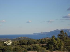 a windmill in the middle of a field with trees at La Canardiere in Casta