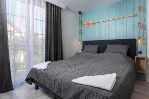 Łóżko lub łóżka w pokoju w obiekcie Morskie Apartamenty "Zefir" "Notos" "Loft" "Gniazdo"