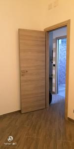 una puerta que conduce a una habitación con suelo de madera en Casa orchidea, en Génova