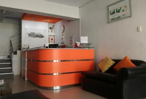 an orange bar in a living room with a couch at HOTEL PUNTA PARIÑAS-TALARA-PERU in Talara