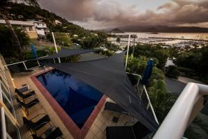 a building with an umbrella on top of it at Sunlit Waters Studio Apartments in Airlie Beach