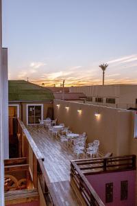 a rooftop deck with tables and chairs on a building at Hotel Boutique Suri in La Serena