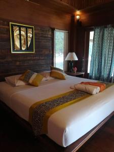 a large white bed in a room with windows at Nangyuan Island Dive Resort in Ko Tao