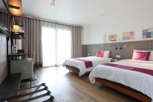 Llit o llits en una habitació de The Mantrini Chiang Rai-SHA Extra Plus
