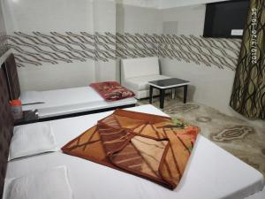 a kite sitting on a bed in a room at Vidya Guest House in Katra