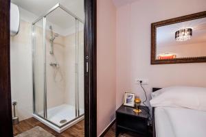 a bathroom with a shower and a bed and a mirror at Villa NEA Seaview! Deluxe apartments in old town! in Rovinj +60 photos