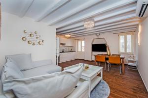 a living room with a couch and a table at Villa NEA Seaview! Deluxe apartments in old town! in Rovinj