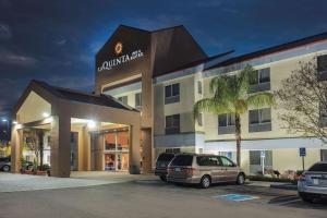 a hotel with a car parked in a parking lot at La Quinta by Wyndham Dublin - Pleasanton in Dublin