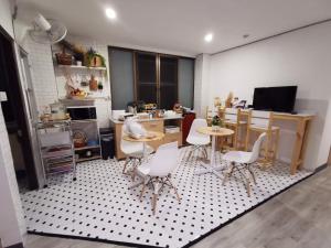 a kitchen with a table and chairs in a room at White House Hostel in Bangkok