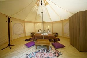 a bedroom in a tent with a bed and a rug at Paliouri in Paliouri