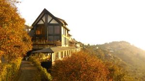 a large building on a hill with trees at Top Cloud Villa in Renai