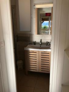 a bathroom with a sink and a mirror at Hotel Les Hauts de Porto-Vecchio in Porto-Vecchio
