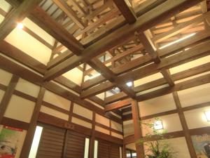 a wooden ceiling in a building with wooden beams at Bunanoyado Koase in Aga