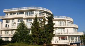a large white building with a large window at Family Hotel Casablanca Green in Varna City