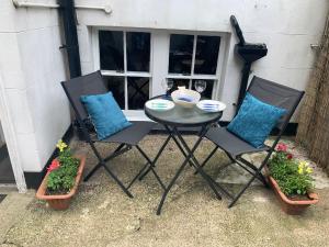 a table and two chairs and some plants at Whitby Wave breaker studio in Whitby