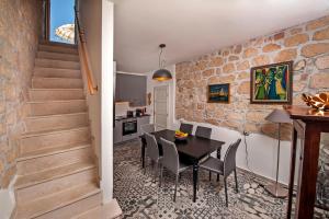 a kitchen and dining room with a table and chairs at Seaview House Rosali in Rovinj