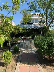 a patio with a table and chairs and a building at Lilia Guest House in Nesebar