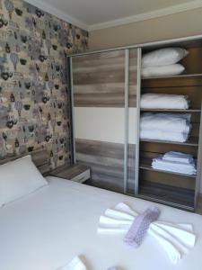 a bedroom with a white bed and a mirror at Apartment See Breeze in Sunny Beach