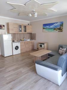 a kitchen and living room with a table and a couch at Apartment See Breeze in Sunny Beach