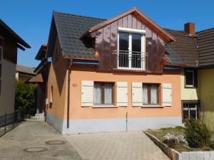 a house with white doors and a black roof at Ferienhaus Seeperle in Bodman-Ludwigshafen