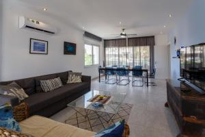 a living room with a couch and a table at Sea Breeze Apartments - 3 Bedroom Apartment in Peyia