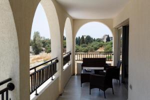 a balcony with arches and a living room with a view at Sea Breeze Apartments - 3 Bedroom Apartment in Peyia