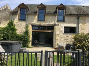 une maison avec une clôture devant elle dans l'établissement Loft P'tite Pomme Azay le Rideau, à Azay-le-Rideau