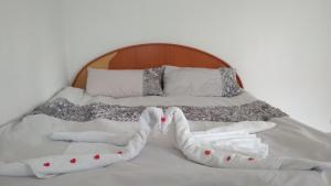 a bed with two pairs of mittens and socks on it at Zacisze in Supraśl