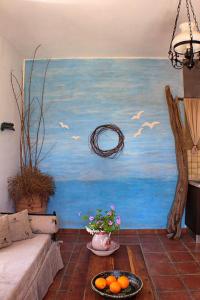 a living room with a painting on the wall at AMPELIA KYTHIRA in Livadi