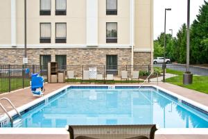 a pool with a person in a costume standing next to a building at Best Western Plus Heritage Rail Inn & Suites in York