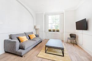 a living room with a couch and a table at Stylish 2 bedroom flat in Knightsbridge in London