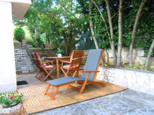 a patio with chairs and a table with a painting at Studio Apartment Tamara in Krk