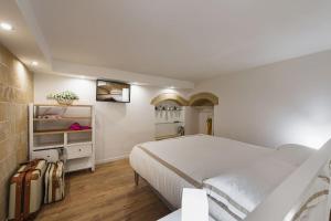 a bedroom with a large white bed and shelves at Diletta Casa Vacanze in Lecce