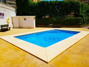 a swimming pool in the middle of a patio at Precioso Apartment Lepanto-Levante in Benidorm