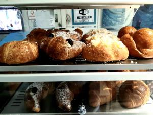 a display case filled with lots of different types of bread at Relais Vista Mare in Pozzuoli