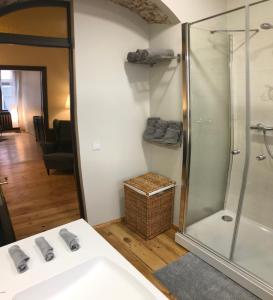a bathroom with a glass shower and a sink at Doma square apartment 2, in the heart of Old town in Riga