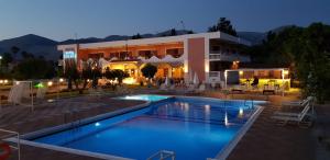 a hotel with a swimming pool in front of a building at Galaxy Hotel in Argostoli