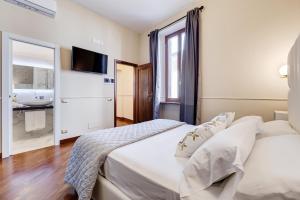 Ένα ή περισσότερα κρεβάτια σε δωμάτιο στο Trevi Private Suites by Premium Suites Collection