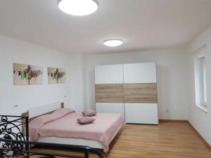 a bedroom with a pink bed and a mirror at Vila Maris in Koper