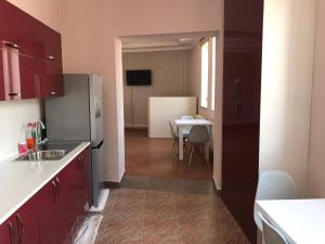 a kitchen with a refrigerator and a table at Liko Hostel in Yerevan