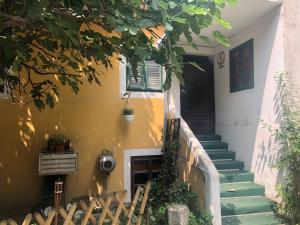 a stairway leading to a house with a yellow wall at Apartment Tkalča in Zagreb
