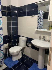 a bathroom with a toilet and a sink at Marinela Apartment in Sarandë