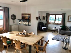 a living room with a wooden table and chairs at Panoramaresidenz Blindau in Reit im Winkl