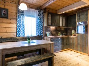 a kitchen with wooden cabinets and a counter top at Dom drewniany Ozwa in Gronków