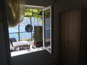 a window in a room with a view of a balcony at Apartments Jovanović in Perast