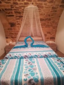 a bed with a canopy in a room at B&B S.Antonio in Bari