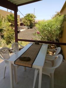 a table and chairs on a patio with a view at Coin de Paradis,Pavillon Doucimar in Porto Novo